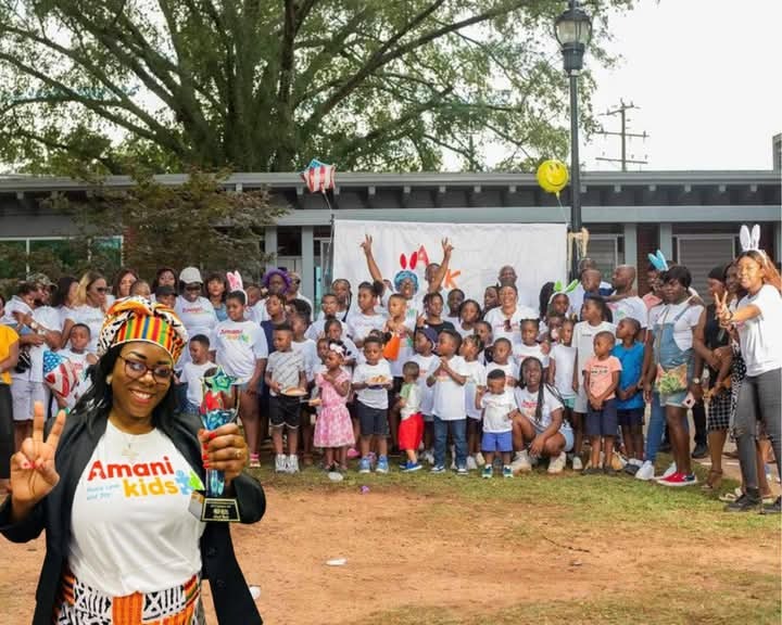 Founder Binti Muzuri Amisi and newcomer children celebrating with trophy at Bisakana Day